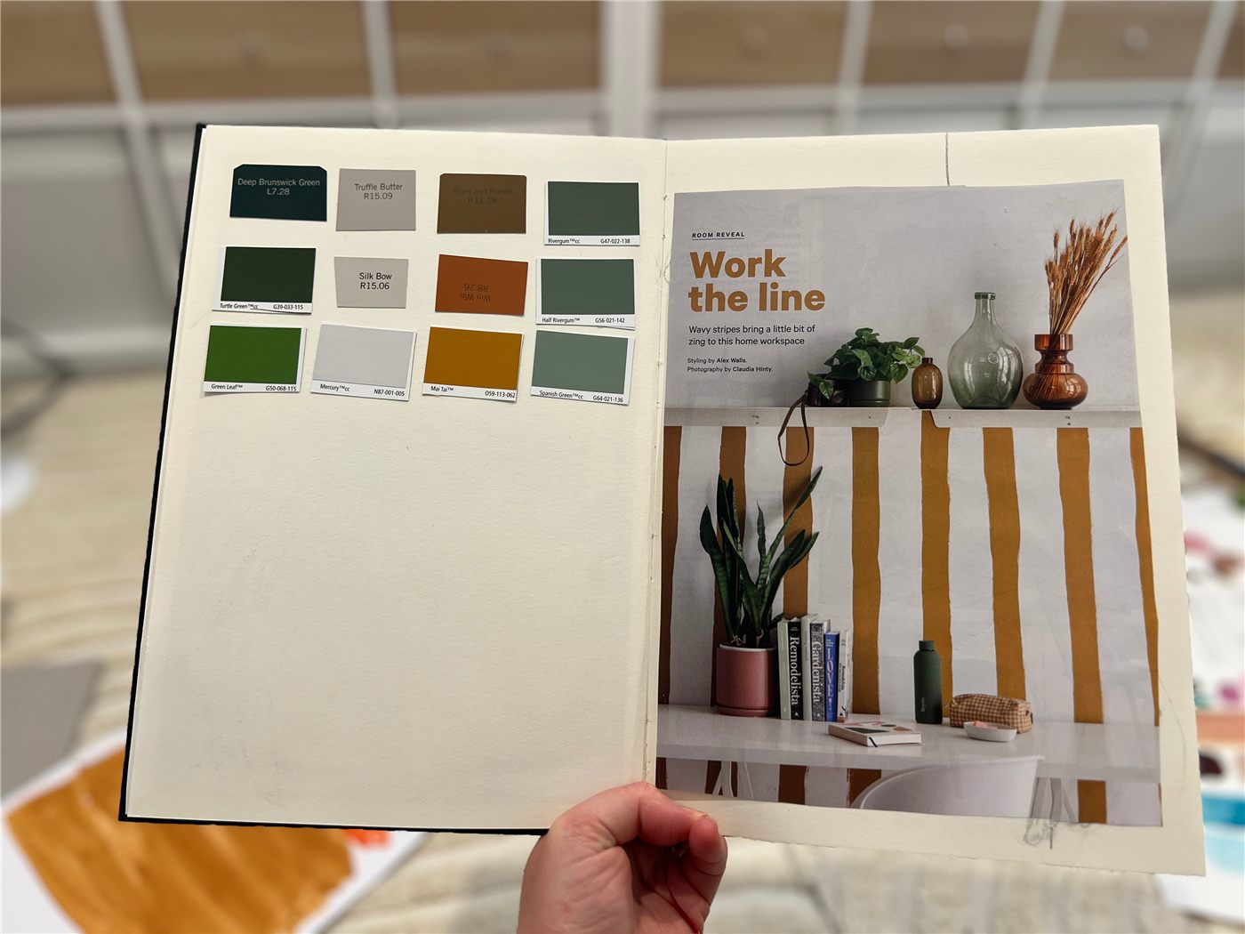 Open sketchbook with a magazine clipping on one page and a hand-painted color palette from that image on the facing page